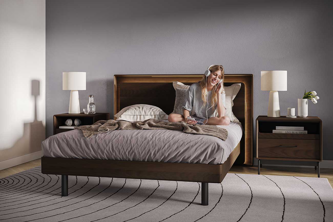 Open storage drawer/bed without mattress showing ribbed frame and dark wood finish with metal legs.