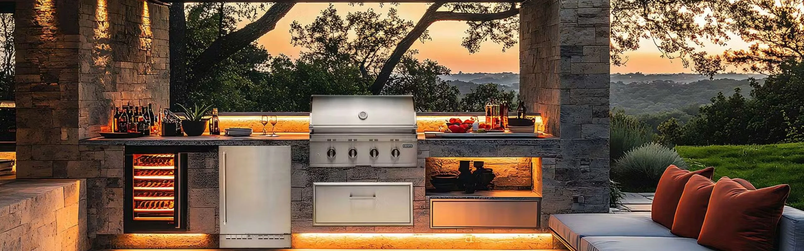 Luxury outdoor kitchen with a built-in grill and wine refrigerator and an outdoor sofa.