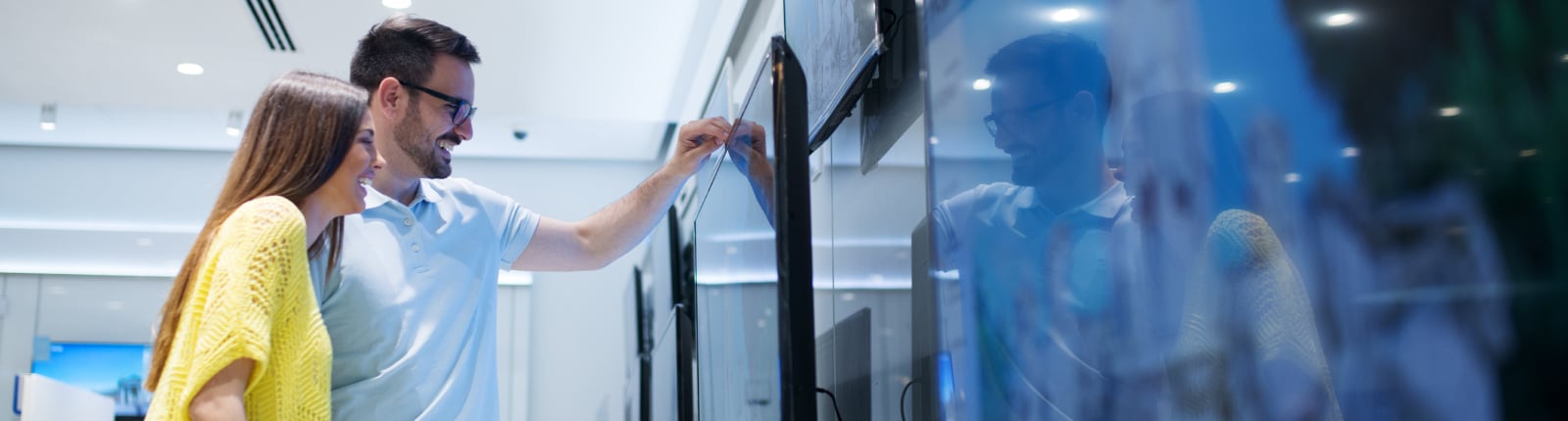 Side by side images of a speaker, a set of kitchen appliances and a TV mounted on a wall
