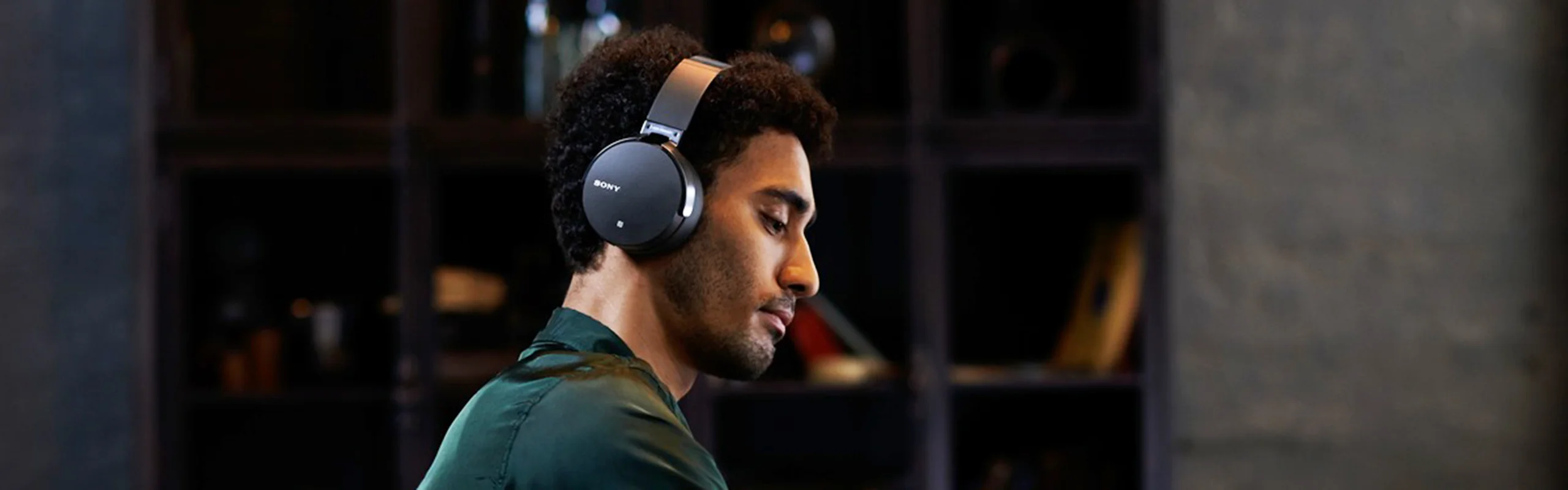 A man wearing a pair of black over-ear headphones
