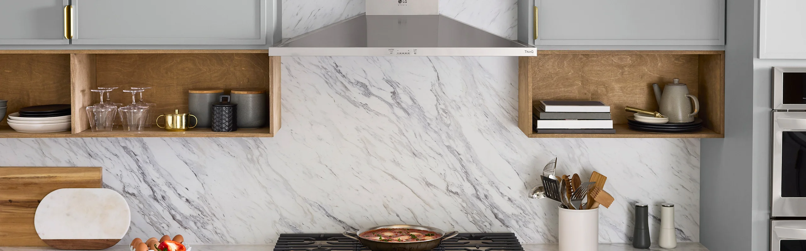 Range surrounded by grey cabinets