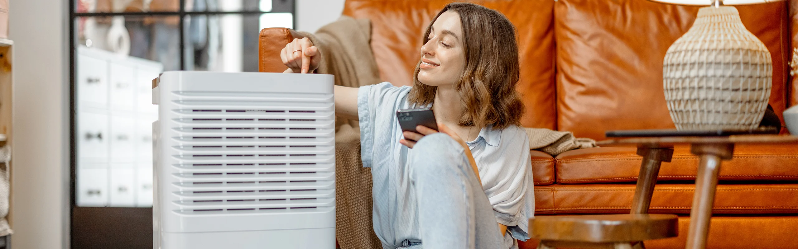 Woman operating dehumidifier