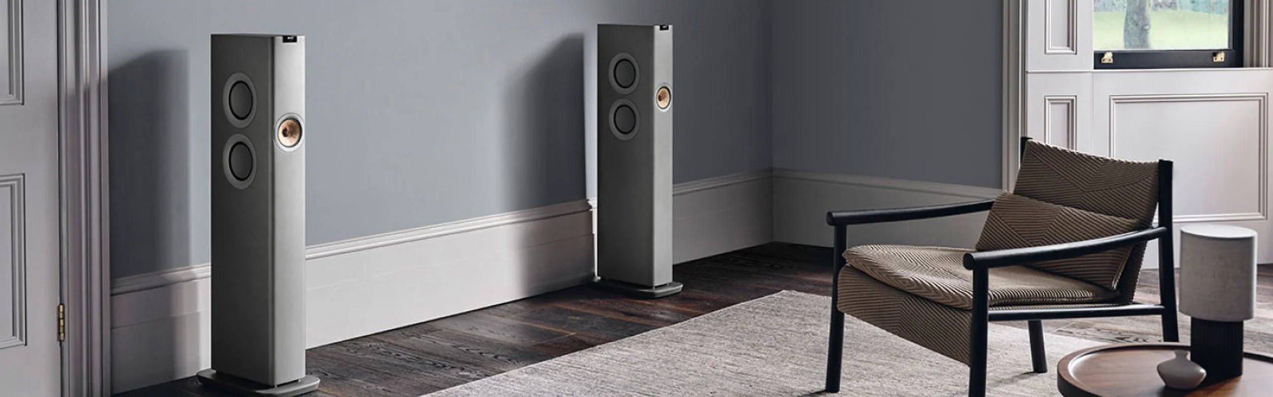 Two tall speakers bookend a cabinet with a turntable on top