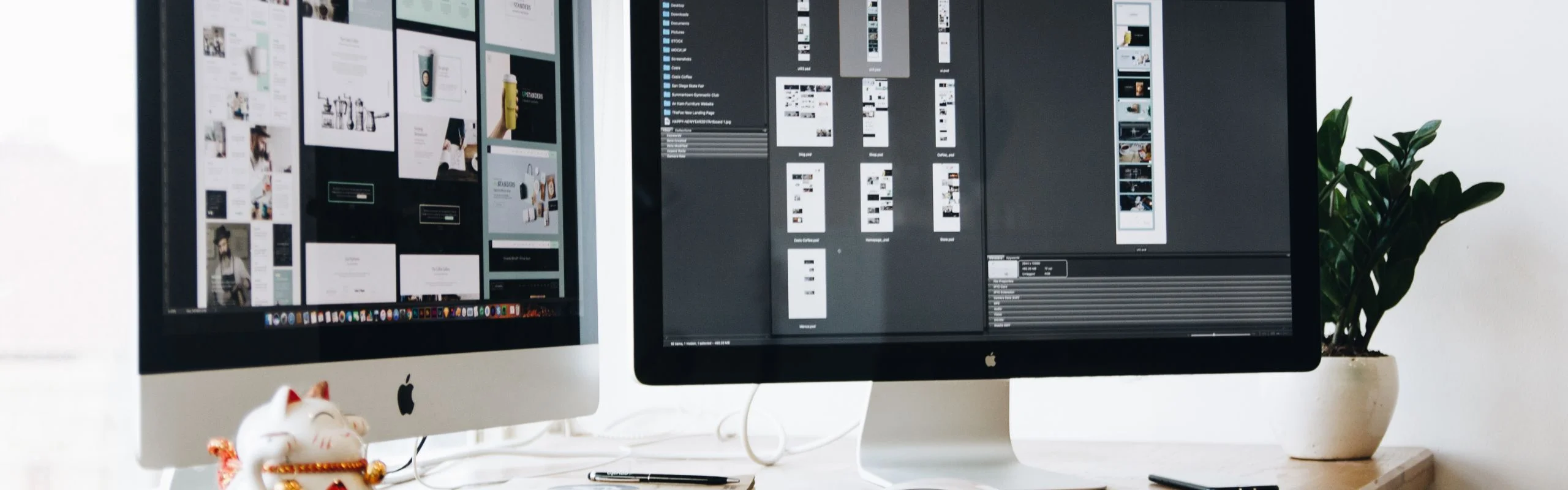 Two computer monitors sitting next to each other on a brightly lit desk.