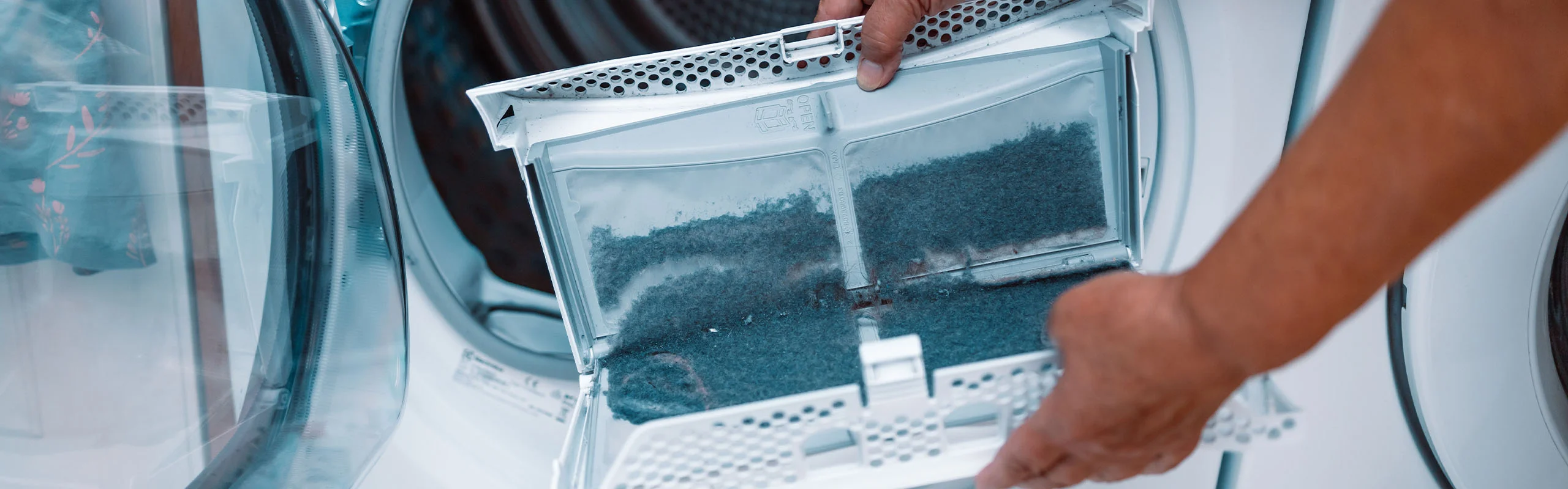Person holding a dirty filter from dryer vent