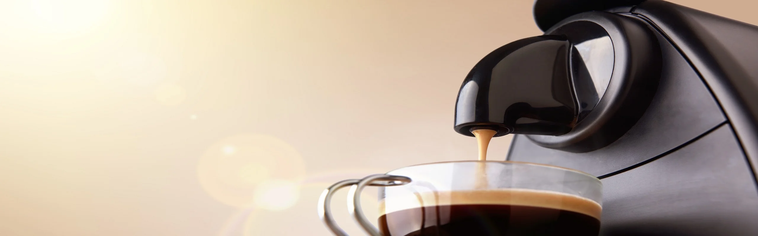 Espresso dripping into cup