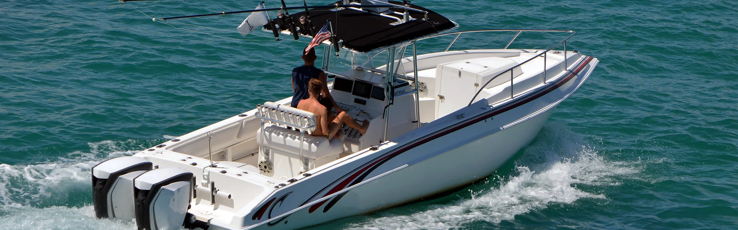 Two guys cruising on a boat out on the open water