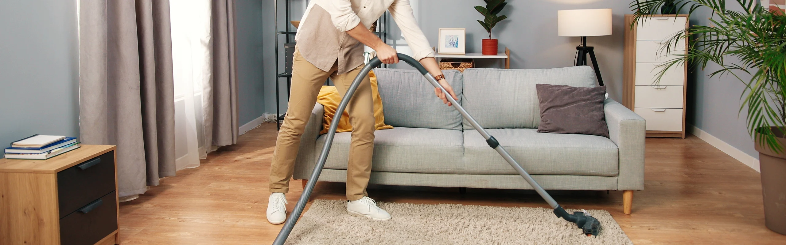 Man vacuuming carpet