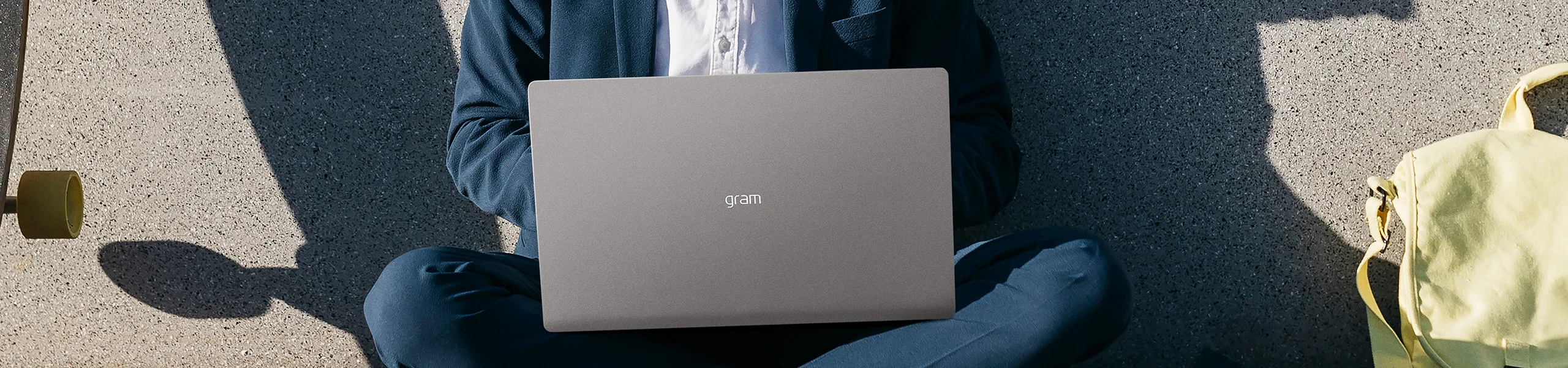 A person in a suit sitting and using an LG gram laptop