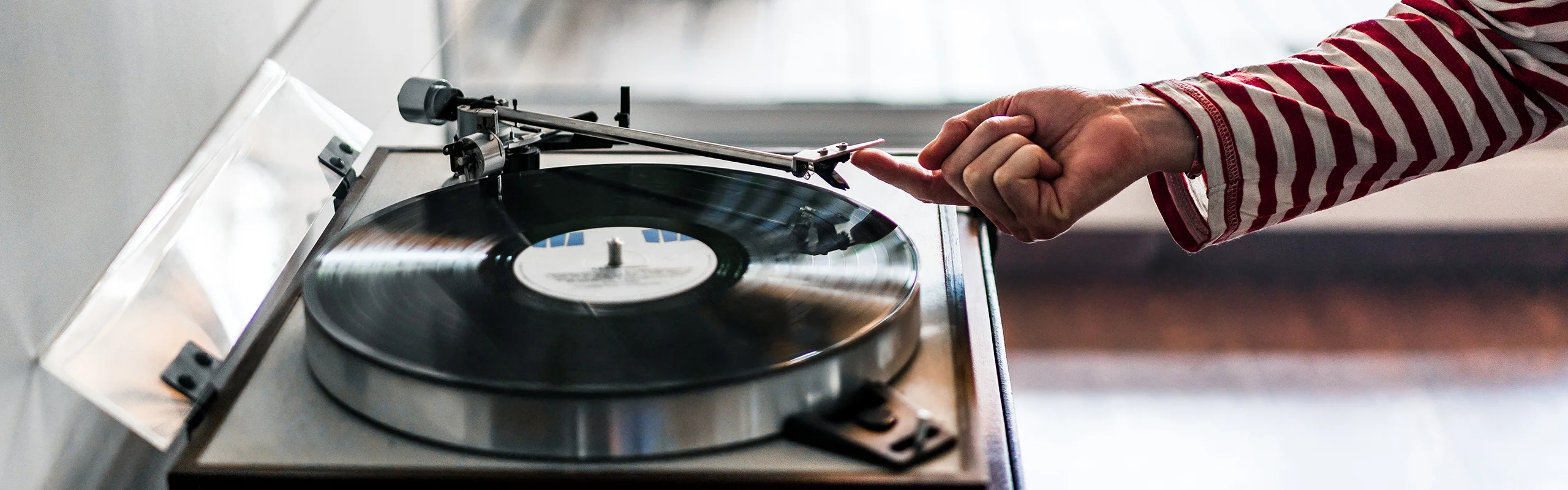 Person putting a record on a turntable